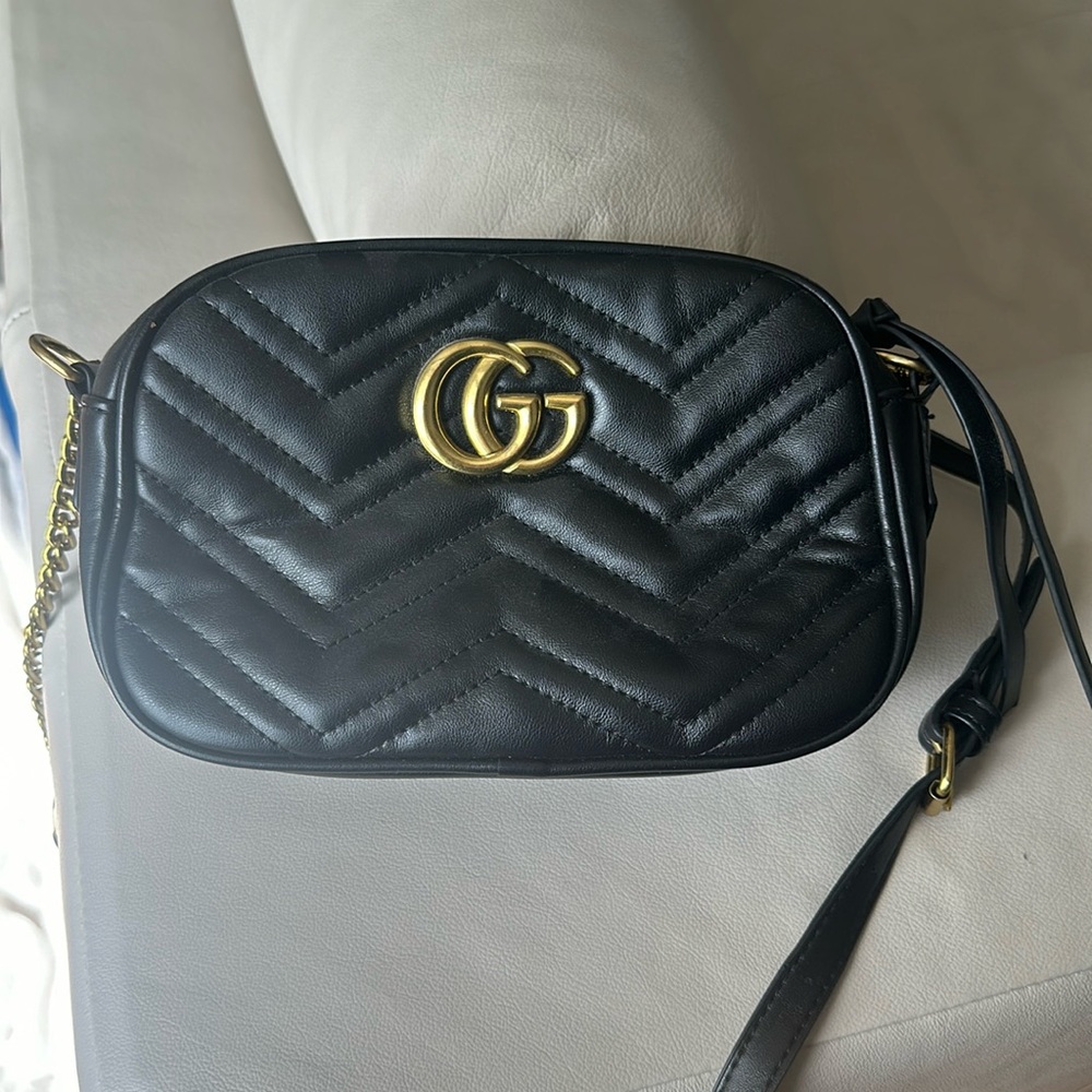 Black and gold oval bag